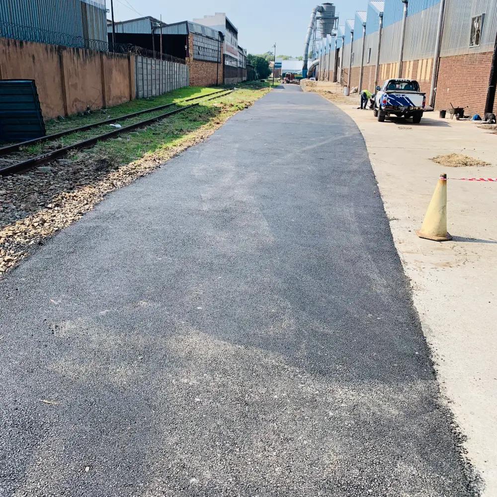 Tarworks crew and machines working through every stage of a surfacing job